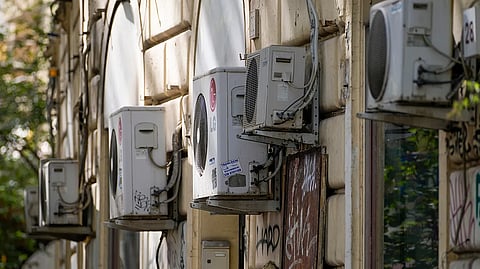Air conditioning external units are seen on the wall of a building in Rome