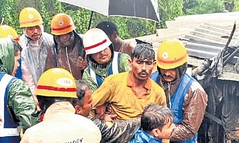 Fire and Emergency Services personnel rescue a labourer from landslide debris in Thirthahalli town on Sunday, August 2, 2026.