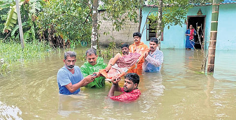 Rescue workers carried bedridden Vijayamma to safety from her house, which was inundated at Thalavady in Kuttanad on Monday.