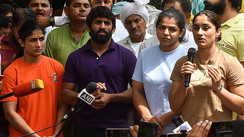 Wrestler Vinesh Phogat, Bajrang Punia and Sangeeta Phogat with others during their protest march from Jantar Mantar to Parliament House, in New Delhi.