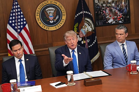 President Donald Trump speaks as Secretary of State Marco Rubio, left, and Defense Secretary Pete Hegseth listen during a cabinet meeting, Friday, July 31, 2026, at Camp David, the presidential retreat, near Thurmont