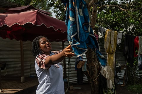Esther Lutula, a 26 year-old woman who is four months pregnant and a mother of four who stopped going for prenatal checkups shortly after the current Ebola outbreak, does the laundry outside her house in Bunia, northeastern, Congo, Tuesday, June 16, 2026. 