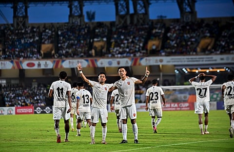 Delhi players celebrate a goal against Jamshedpur