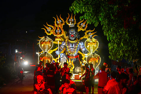 Devotees pull the giant Dandi Kanwar, which features an illuminated Shiva idol, during the ongoing Kanwar Yatra in Haridwar.  