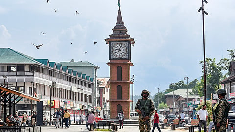 Armed security personnel stand guard near Ghanta Ghar as security tightens in and around Lal Chowk on the 7th anniversary of the revocation of Article 370, in Srinagar on Wednesday, Aug. 05, 2026.