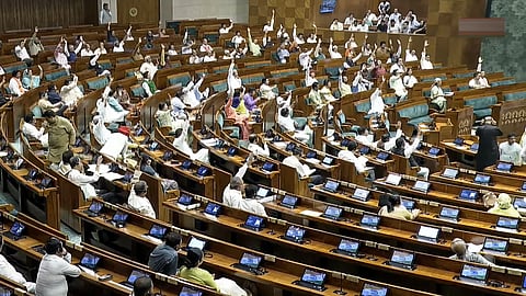 Lok Sabha members raise their hands during the passing of a bill in the House during the Monsoon session of Parliament, in New Delhi, Wednesday, Aug. 5, 2026.