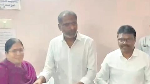 Energy Minister Gottipati Ravi Kumar and Collector Raja Babu distribute REMZ land compensation.