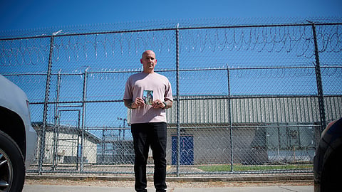 Army Staff Sgt. Alexis Jaramillo poses with a photo of his wife, Maisa Lopes Eliaser, a Brazilian national who is being detained by ICE, before visiting her at the South Louisiana ICE Processing Center in Basile, La., Sunday, Aug. 2, 2026.