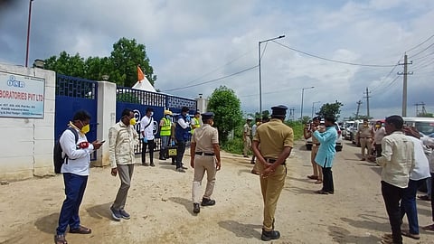 People and police personnel gathering in-front of C.I.L Pvt Limited.