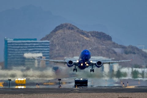 A jet takes flight as heat ripples radiate from the runway at Sky Harbor International Airport in Phoenix, on July 25, 2023.