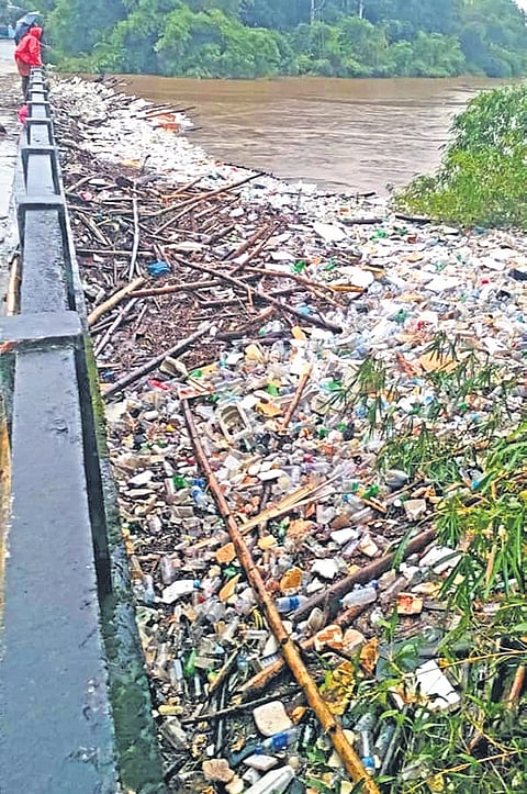 Waste accumulated at the Paduthodu bridge in Mallappally as rising water levels carry debris downstream.