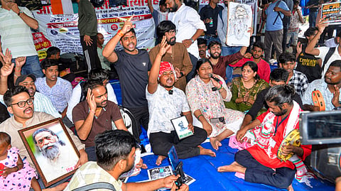 Students and aspirants hold placards and stage an indefinite protest against the Jharkhand Government regarding the irregularities of exams and paper leak of Jharkhand Public Service Commission and Jharkhand Staff Selection Commission, at Jaipal Singh Stadium, in Ranchi, Thursday, Aug. 6, 2026.