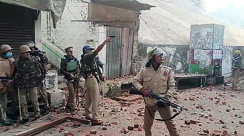In this photo from Nov 24, 2024, police and paramilitary personnel using tear gas to control the situation at the site where an incident of stone pelting took place when a survey team arrived at the Shahi Jama Masjid to conduct a survey of the mosque, in Sambhal.