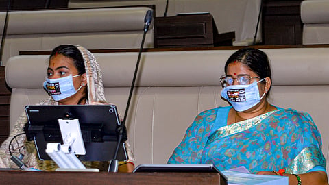 BJP MPs Ragini Singh, right, and Purnima Sahu wear a face mask printed with a demand to cancel the 14th JSSC examination regarding the JPSC and JSSC paper leak issues during the first day of the monsoon session of the Jharkhand Legislative Assembly, in Ranchi, Thursday, Aug. 6, 2026. 