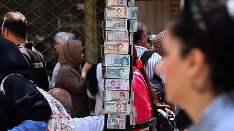 People walk past shops and stalls as they visit the Grand Bazaar in Tehran on August 1, 2026.