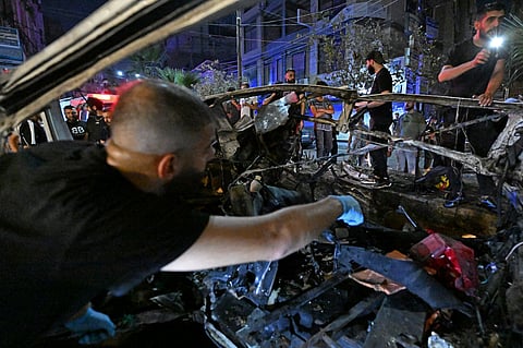 Rescuers and onlookers inspect the wreckage of a minibus at the site of a blast near Damascus August 6, 2026.
