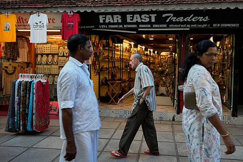 Keith Hallegua, center, walks past a handicrafts store toward the 458-year-old Paradesi Synagogue in the historic Jew Town neighborhood of Kochi, India, Thursday, May 21, 2026.