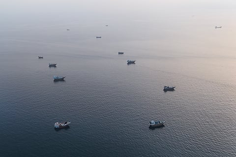 This aerial photograph shows boats anchored off Oman’s northern Musandam Peninsula near the Strait of Hormuz on June 27, 2026.
