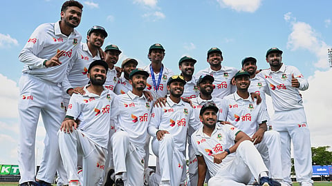 Bangladesh players pose for a team photo as they celebrate after defeating Australia on day four of the first cricket test in Darwin, Australia, Sunday, Aug. 16, 2026. 