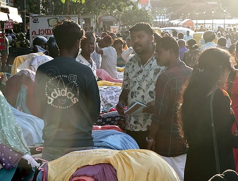 Men allegedly collecting money from footpath vendors during the Onam shopping rush at East Fort. 