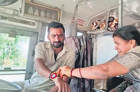 Swapna ties a rakhi to her brother, Menda Raju, during a brief stop in Karimnagar 
on Friday. Raju was on duty, driving from Godavarikhani to Hyderabad.