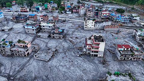 An aerial view of damaged structures covered in thick mud and debris in the aftermath of flash floods, at Devighat, in Nuwakot district, Nepal, Saturday, Aug. 29, 2026. 