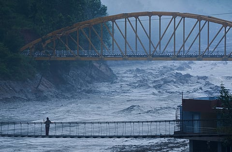 A resident looks at the swollen Trishuli river in Galchhi, Dhading District, Nepal, Sunday, Aug. 30, 2026. 