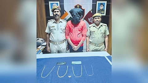 Deepak Pradhan held by police.