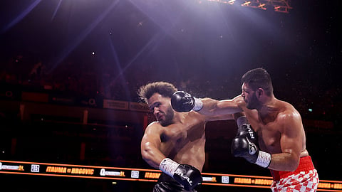 Boxer Filip Hrgovic , right, punches Moses Itauma during their vacant IBF world heavyweight title, Saturday, Aug. 29, 2026, in London. 
