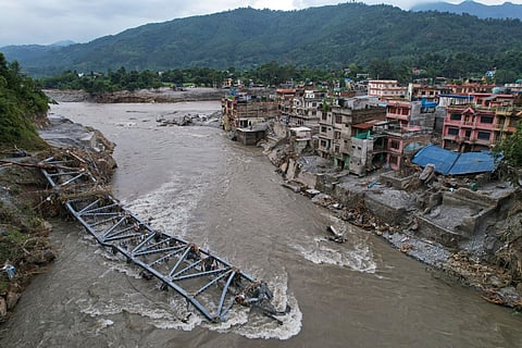 A drone view of a bridge damaged by flash flooding along the Tadi River in the Devighat area of Nuwakot district, Nepal, Saturday, Aug. 29, 2026.
