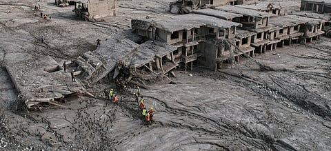 A drone view shows rescue workers inspect the area and damaged structures following recent flash flooding along the Trishuli River in the Devighat area of Nuwakot district, Nepal, Saturday, Aug. 29, 2026.
