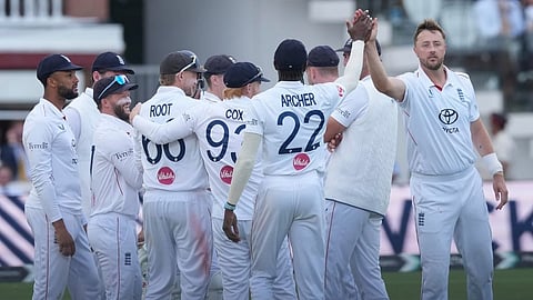 England's Ollie Robinson, right, celebrates with teammates the dismissal of Pakistan's Shan Masood on day four of the second cricket test match between England and Pakistan in London, Sunday, Aug. 30, 2026.