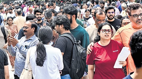 Aspirants leave from an exam centre after appearing in the NEET-PG in Delhi