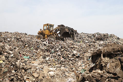 Workers segerates garbages at Vellalore dump yard in Coimbatore. 