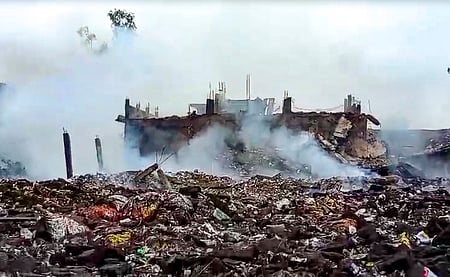 Smoke erupts from charred remains after an explosion in a firecracker factory in the Pipri area, Kaushambi, on Monday, Aug. 31, 2026.