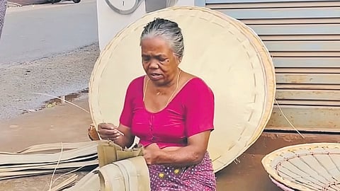 Chandravathi making and selling thoppi kudas at Wandoor market