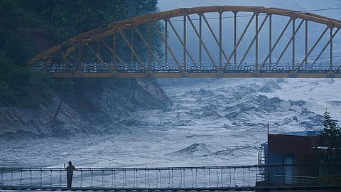 A resident looks at the swollen Trishuli river in Galchhi, Dhading District, Nepal, Sunday, Aug. 30, 2026. 