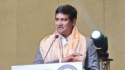 Minister Srinivas addressing a meeting in Malaysia on Sunday.