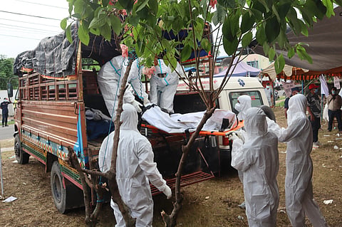 Rescuers carry bodies of flash flood victims for a mass burial in Chitwan, Nepal, Saturday, Aug. 29, 2026.