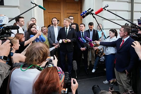 Yabloko party leader Nikolai Rybakov, center, speaks to journalists and supporters after a hearing on a lawsuit to bar the party from the upcoming parliamentary elections, at the Russia's Supreme Court, in Moscow, Monday, Aug. 10, 2026.