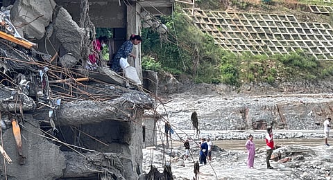 People try to retrieve whatever remains from a building following flash floods in Bidur, Nepal, on Wednesday, Sept. 2, 2026.