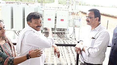 Bescom MD N Shivashankara with Narayanswamy, a farmer who provided land for the installation of a solar power plant, in Chikkaballapur on Wednesday  