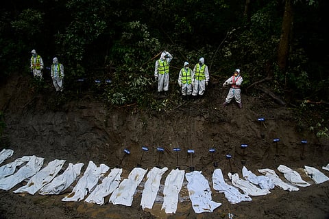 Nepal police personnel prepare the bodies of flash flood victims for a mass burial in Kathmandu, Nepal, Tuesday, Sept. 1, 2026.