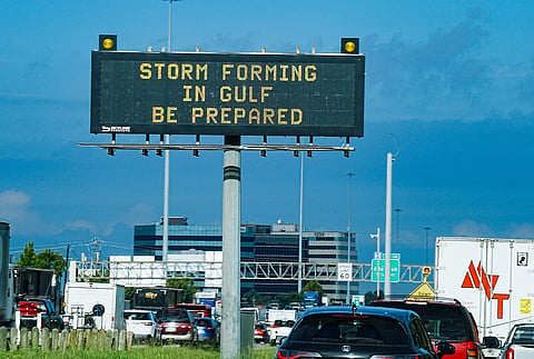 Motorists drive by Texas Department of Transportation signs on I-610 as Tropical Storm Edouard approaches in Houston, Tuesday, Sept. 1, 2026.