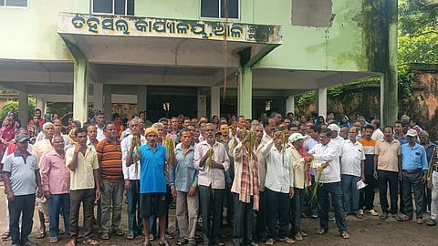 Farmers staging protest outside Aul tehsil office on Wednesday.