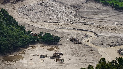 A view of damaged and half-buried buildings under silt and debris following devastating flash floods, at Betrawati market, in Nuwakot district, Nepal, Wednesday, Sept. 2, 2026. 
