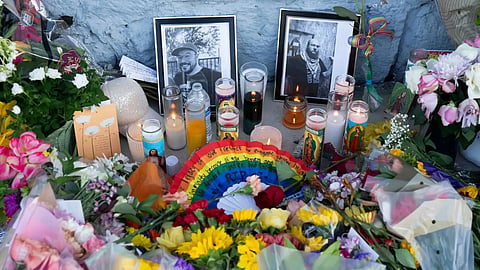 A growing memorial sits outside the Venture-N bar in Tucson, Ariz., Tuesday, Sept. 1, 2026, for Vincent Anthony Siquieros and Cameron Davis Capara, who were fatally shot in the parking lot of the gay bar shortly after midnight on Monday.