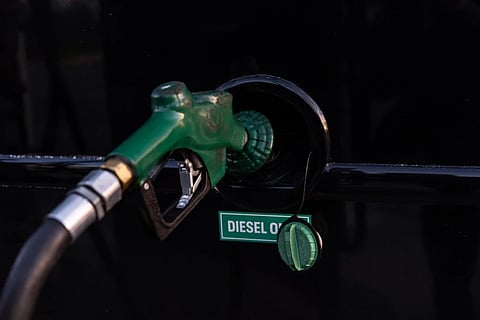 A nozzle pumps diesel into the fuel tank of bus in Orange, Calif., Tuesday, April 7, 2026. 