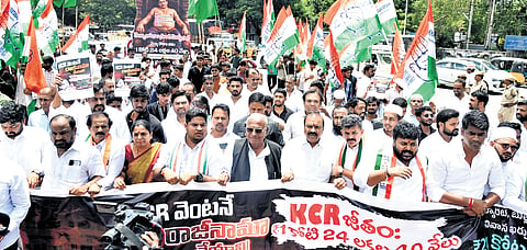 Khairatabad DCC members stage a protest rally, demanding the resignation of BRS president K Chandrasekhar Rao from the Assembly, in Hyderabad on Friday