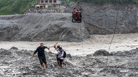 Residents pull a newly installed zipline to help people commute across the Trishuli river in the aftermath of flash floods at Bidur in Nepal’s Nuwakot district, Nepal, Wednesday, Sept. 2, 2026. 